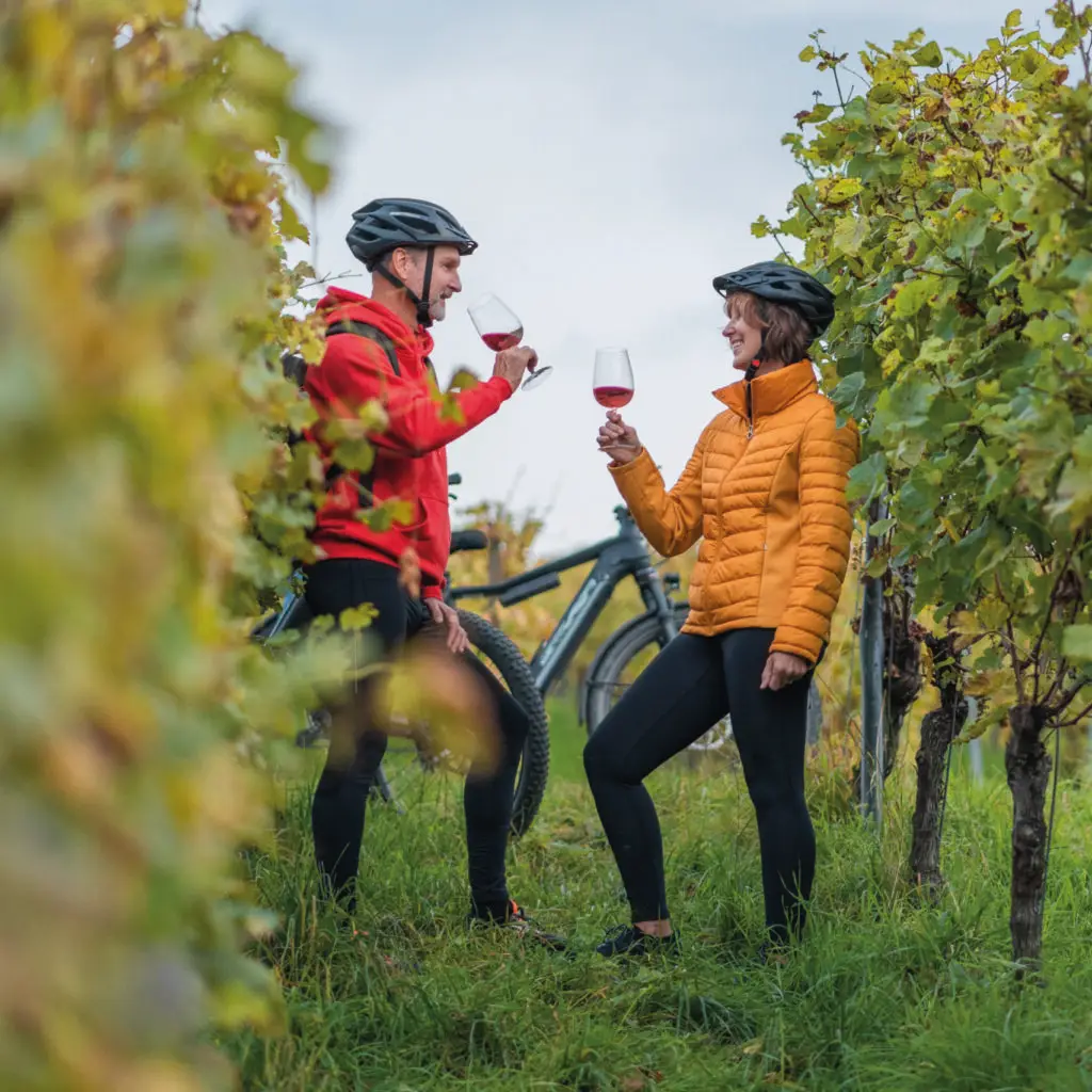 They enjoy a glass of rosé after their ride in the European Alps